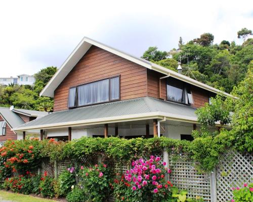 a house with a fence and flowers at Annick House Bed and Breakfast in Nelson