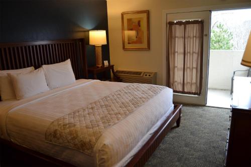 a hotel room with a large bed and a window at Cascades Inn in Bloomington