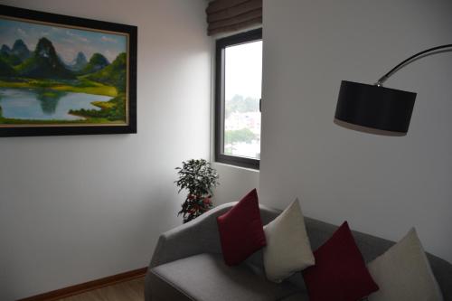 a living room with a couch and a window at Max Boutique Hotel in Cao Bằng