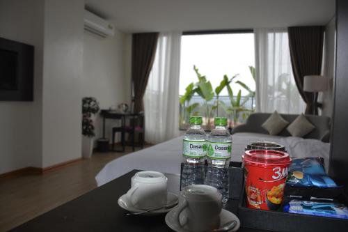 a table with three bottles of water on top of a room at Max Boutique Hotel in Cao Bằng