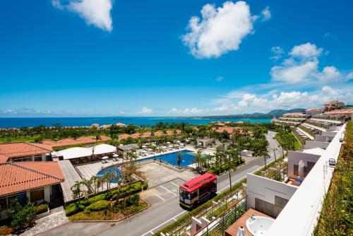 an aerial view of a city with a bus at Kanucha Bay Hotel & Villas in Nago