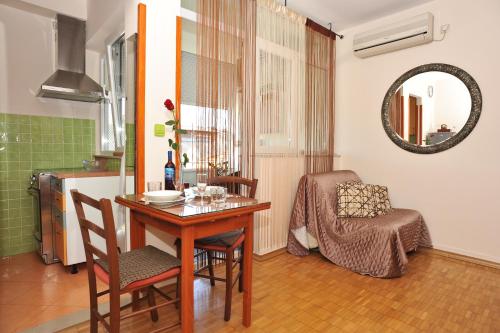a dining room with a table and a chair at Zadar Old Town Apartments II in Zadar