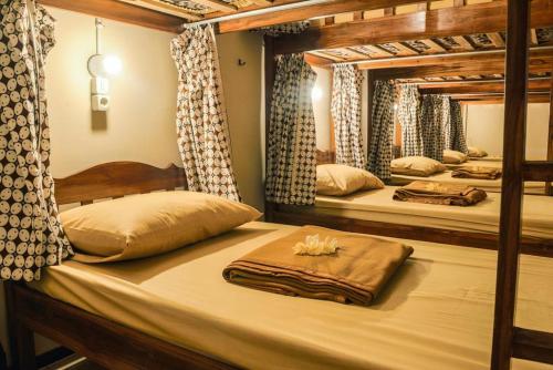 a room with three bunk beds in a bedroom at Rumah Larasati in Malang