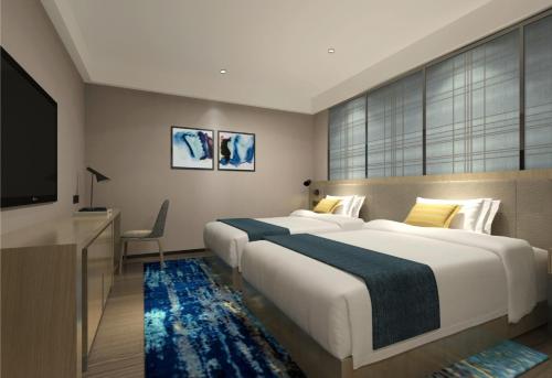 Postel nebo postele na pokoji v ubytování Echarm International Hotel Canton Tower Pazhou Convention and Exhibition Center Lujiang Metro Station Branch - Free Shuttle Bus to Canton Fair Complex During Canton Fair Period