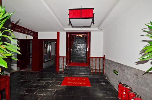 a hallway with a red door in a building at Qianmen Courtyard Hotel in Beijing