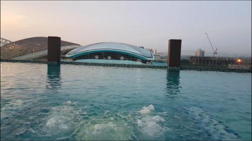 a large building in the middle of a body of water at Emira Residence Sek 13 Shah Alam Wi-Fi Netflix in Shah Alam