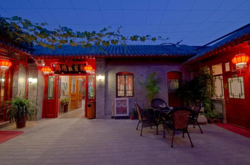 a patio of a house with a table and chairs at Qianmen Courtyard Hotel in Beijing