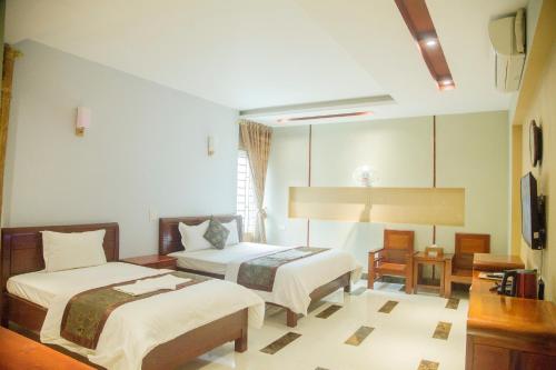 เตียงในห้องที่ Khách Sạn Hoàng Gia Lào Cai - Hoang Gia Hotel