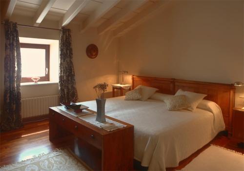 a bedroom with a large bed and a window at Luxuriously restored farmhouse near Girona in the heart of Catalunya in Sant Gregori