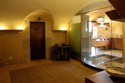 a room with a door in a room with a kitchen at Luxuriously restored farmhouse near Girona in the heart of Catalunya in Sant Gregori