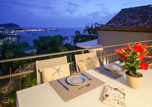 a dining table with a view of the ocean at Villa Caruso in Ischia
