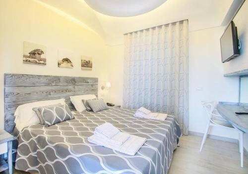 a bedroom with a bed and a desk and a sink at Villa Caruso in Ischia