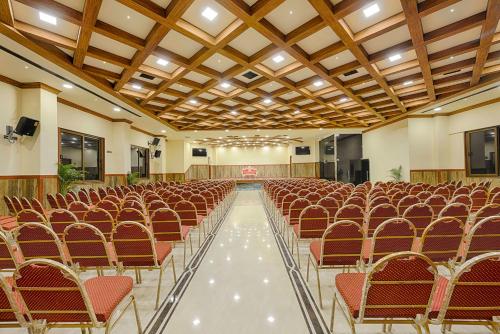 an empty hall with rows of chairs and a ceiling at Hotel Ramraj Regency in Nāgercoil