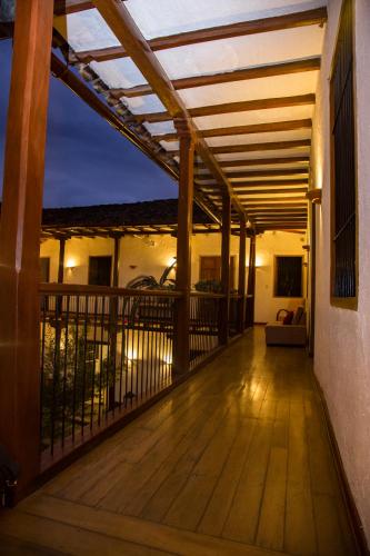 a deck with a pergola on a house at La Casona Monsante in Chachapoyas