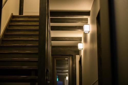 a stairway in a building with two lights on it at JINYA Fujikawaguchiko in Fujikawaguchiko
