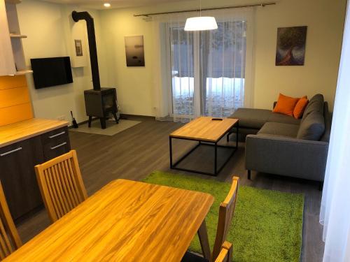 a living room with a couch and a table at Poilsio apartamentai "Jolita" in Druskininkai