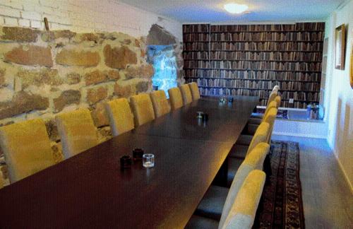 a conference room with a long table and chairs at Hotel Töyrylä Manor in Artjärvi
