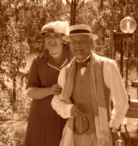 a woman standing next to a man wearing a hat at Hotel Töyrylä Manor in Artjärvi