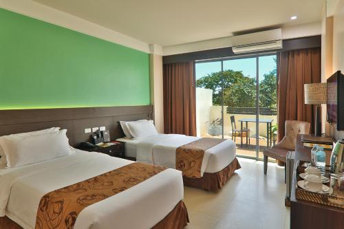 Postel nebo postele na pokoji v ubytování Kew Hotel Tagbilaran