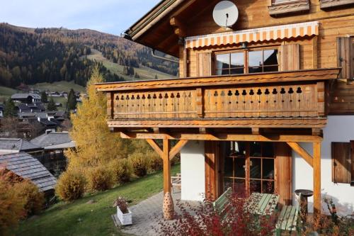a wooden house with a balcony on top of it at Chalet Heidi in Bad Kleinkirchheim