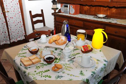 a table with a breakfast of coffee and pastries on it at La Casa Del Sole in Bomarzo