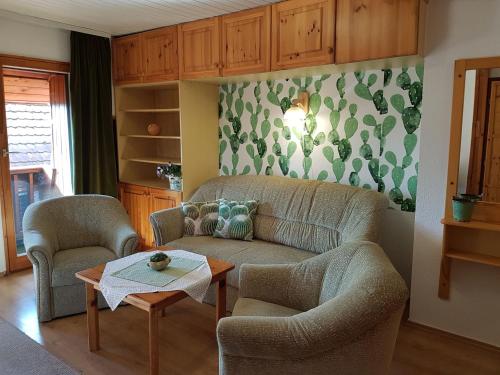 a living room with a couch and two chairs and a table at Kaktusz Villa Heviz in Hévíz