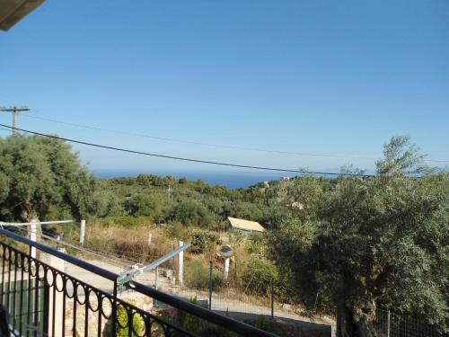 a view of the ocean from the balcony of a house at Monika Lefkada in Tsoukaladhes