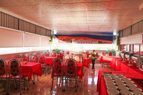 a dining room with red tables and chairs at Khách Sạn Flower Sky Nha Trang in Nha Trang