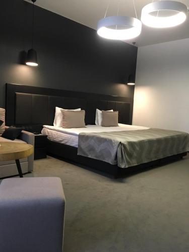 a bedroom with a large bed with white pillows at Sobi Hotel in Vyshhorod