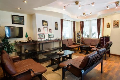 a living room with a fireplace and a tv at Victoria Hotel Borovets - Free Parking in Borovets