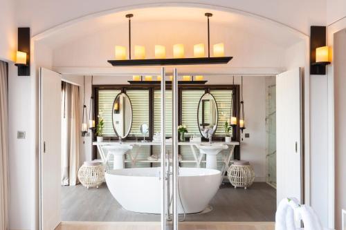 a bathroom with two sinks and a bath tub at The Shore At Katathani - Adult Only - SHA Extra Plus in Kata Beach