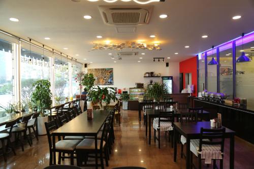 a dining room with tables and chairs in a restaurant at Lavita hotel in Seoul