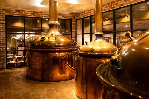 a restaurant with two large wooden vases on the floor at Hotel Okura Fukuoka in Fukuoka