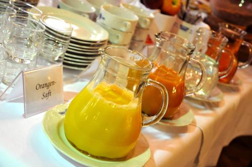 a pitcher of orange juice on a plate on a table at Hotel Zum Goldenen Hirschen in Freistadt