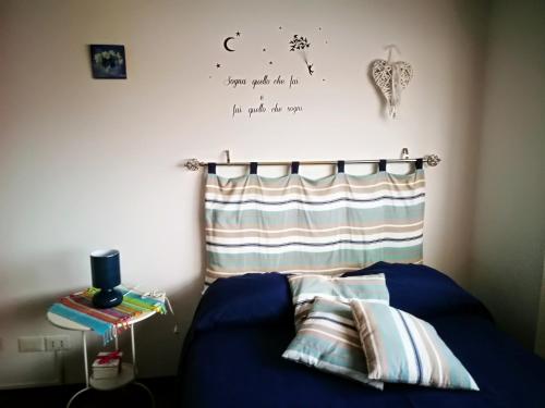 a bedroom with a blue bed with pillows on it at Blue Apartment in Pescara