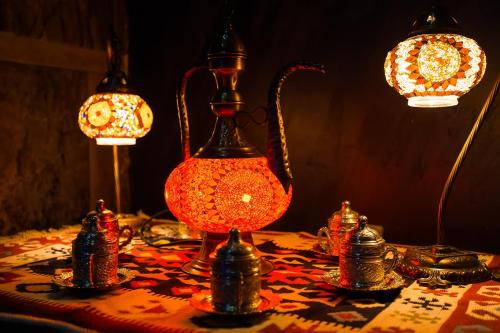 a table with three lamps on top of a table at Almaty Grand Erbil Hotel in Almaty