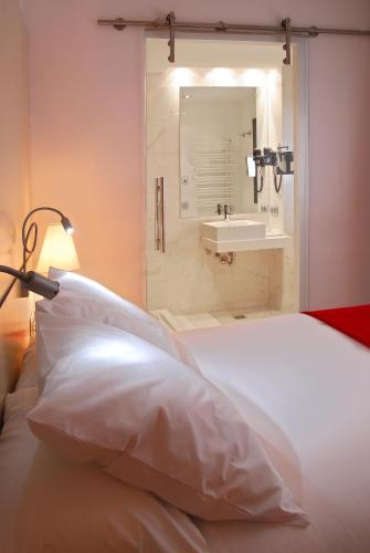 a bedroom with a bed with a sink and a lamp at Grupotel Gran Via 678 in Barcelona
