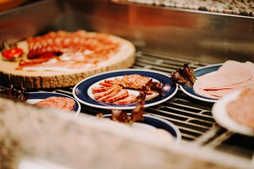 a group of plates of food on a grill at Hotel Achtermann in Braunlage