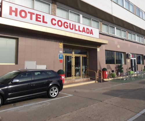 a black car parked in front of a hotel colocalia at Hotel Cogullada in Zaragoza