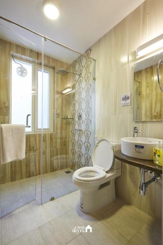a bathroom with a toilet and a shower and a sink at Ranikunj Boutique Hotel in Kathmandu