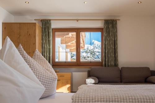 a bedroom with a bed and a window at Apartments Foidl in Kitzbühel