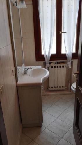a bathroom with a sink and a window at Lido di Venezia Mare e Cinema in Venice-Lido