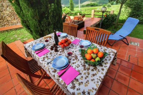 a table with a bowl of fruit on a patio at Podere Il Tigliolo in Castiglione dʼOrcia