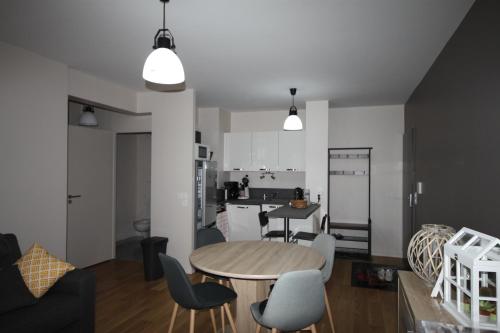 a kitchen and dining room with a table and chairs at A1 - Résidence La Montille in Le Mont-Dore