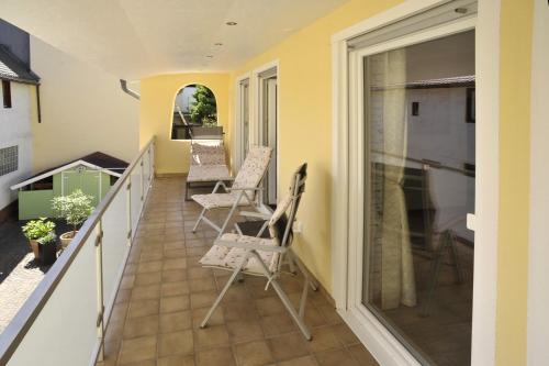 a balcony of a house with chairs on it at Fronhof 3 in Nierstein