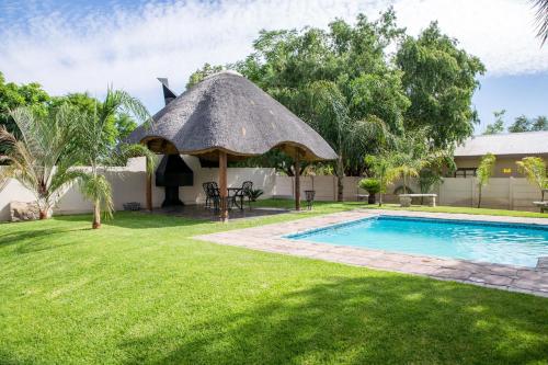 a gazebo next to a swimming pool at Schroderhuis Guesthouse NO LOADSHEDDING GOOD WIFI in Upington