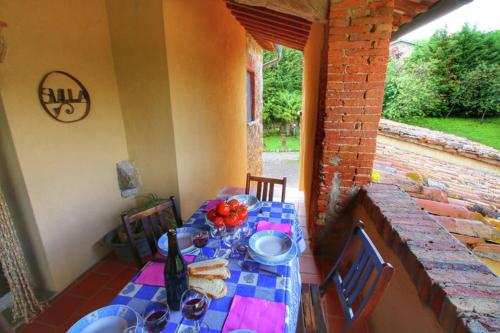 a table with a blue and pink table cloth on a patio at Podere Il Tigliolo in Castiglione dʼOrcia