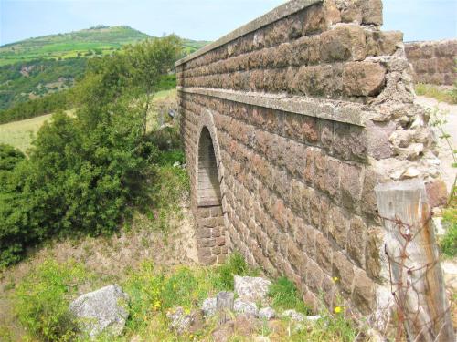 an old brick wall on the side of a hill at Su Cuile historical country house with barbecue in Martis