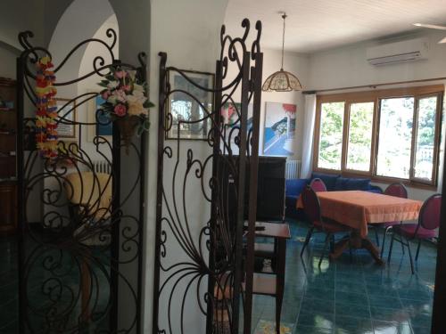 a living room with a gate with a table at Villaverde in Positano