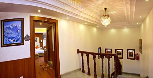 a hallway with a staircase and a ceiling with a chandelier at Kumari Boutique Hotel in Kathmandu